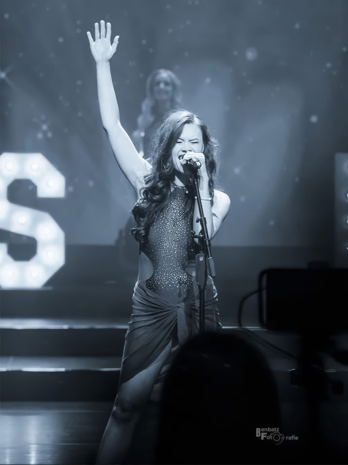 Singing on stage, black and white